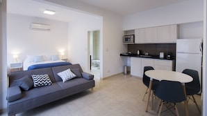 A modern apartment with a living area, kitchenette, and a bedroom. - TPYN Palermo (Buenos Aires)