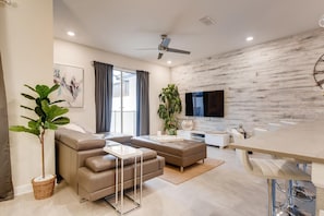 Relax in this stylish living room with a comfortable sofa, coffee table, and dining area, perfect for unwinding.