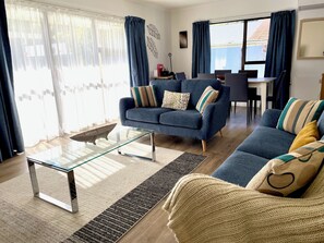 Flat-screen TV, DVD player, books, video library