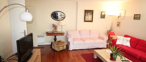A living room with a television, sofa, and coffee table.