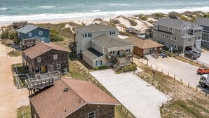 A coastal residential area with houses, a beach, and a view of the ocean. - Sandfiddler | Oceanfront | Dog Friendly, Private Pool, Hot Tub | Nags Head (Nags Head)