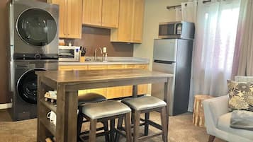 Fridge, microwave, coffee/tea maker, cookware/dishes/utensils