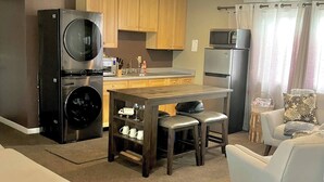 A compact living space with a kitchenette, a dining area, and a seating area. - Ravens Sunny Days King Studio w/Kitchenette, w/d, deck fire pit/grill (Westcliffe)