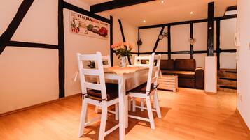Enjoy meals in this stylish dining area with a beautifully set table and comfortable seating.