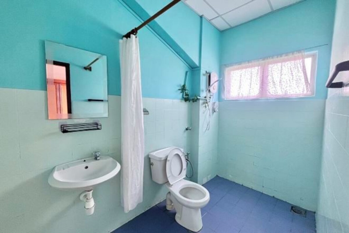A bathroom with a sink, toilet, and shower curtain.