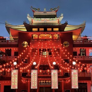 A traditional building with a prominent year displayed on the roof, multiple balconies, and red lanterns hanging in front. - Heng Ann Guest House (Malacca City)