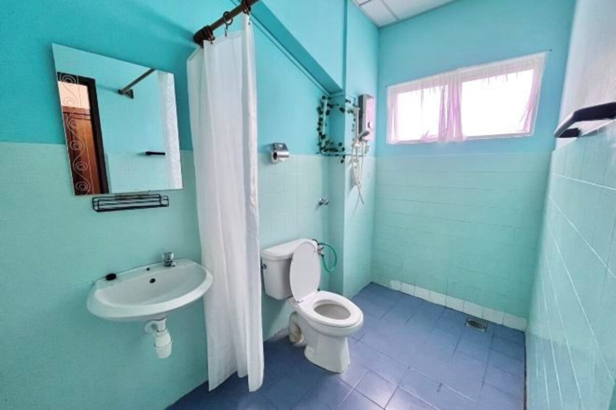 A bathroom with a sink, toilet, and shower.