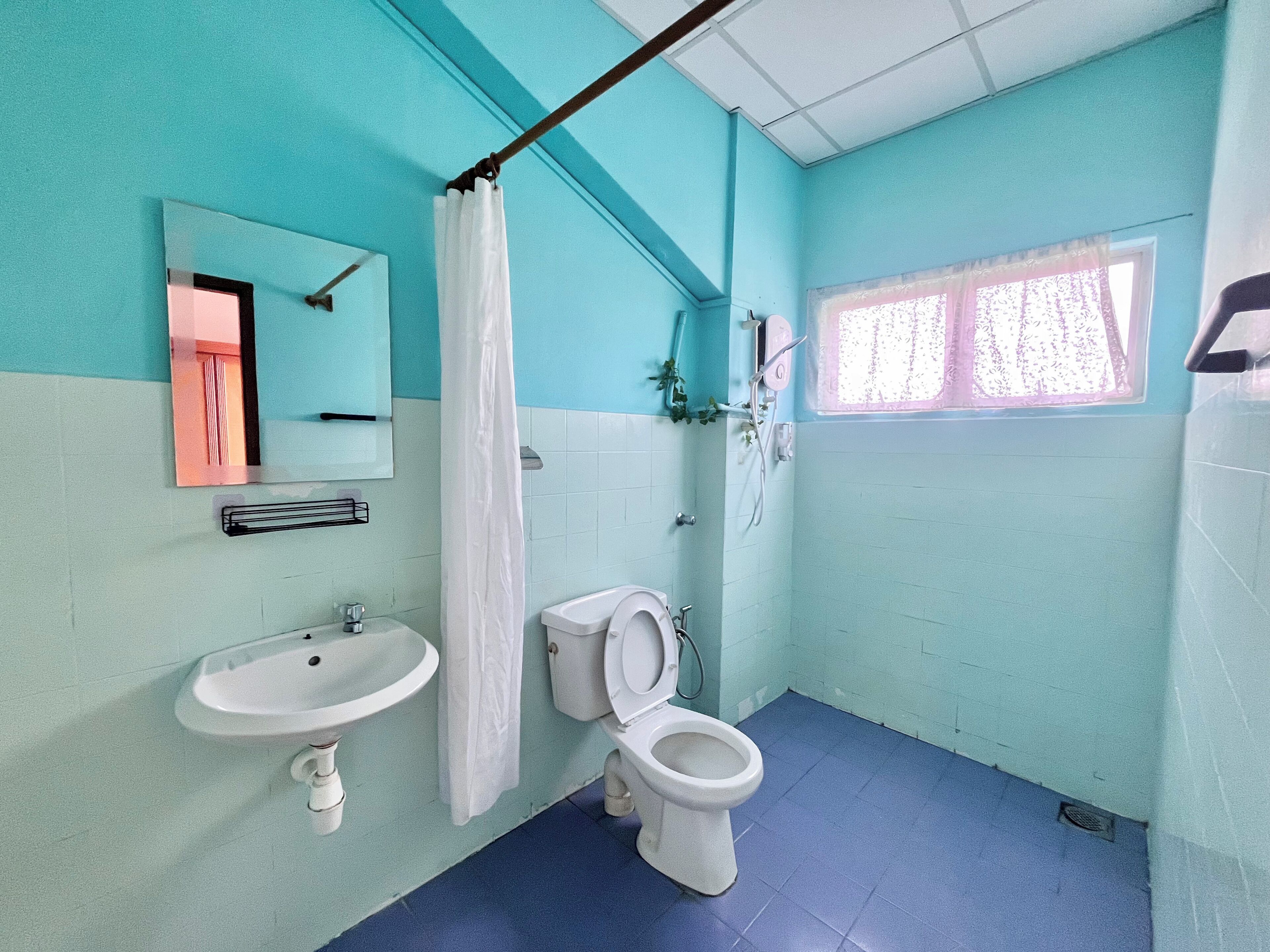 A bathroom with a sink, toilet, and shower.