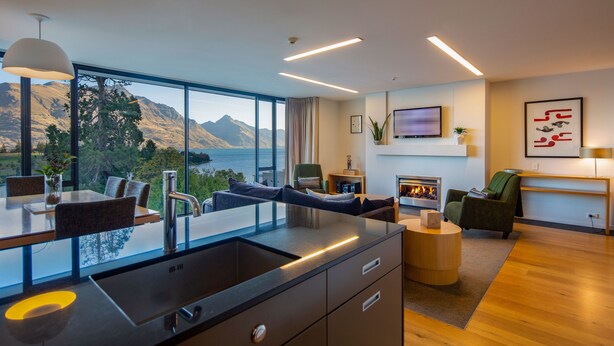 A modern kitchen with a large window overlooking a scenic mountain view. - 3-BDR Apartment with Panoramic Views & Fireplace (Queenstown)