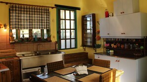 A compact kitchen with a sink, stove, and dining area.