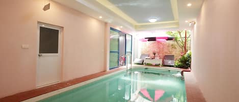 Indoor pool, pool umbrellas, pool loungers