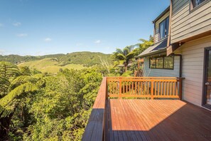 A wooden deck with a view of a hilly landscape. - Retreat on the Ridge - Lake Ōkareka, Sleeps 8 (Rotorua)