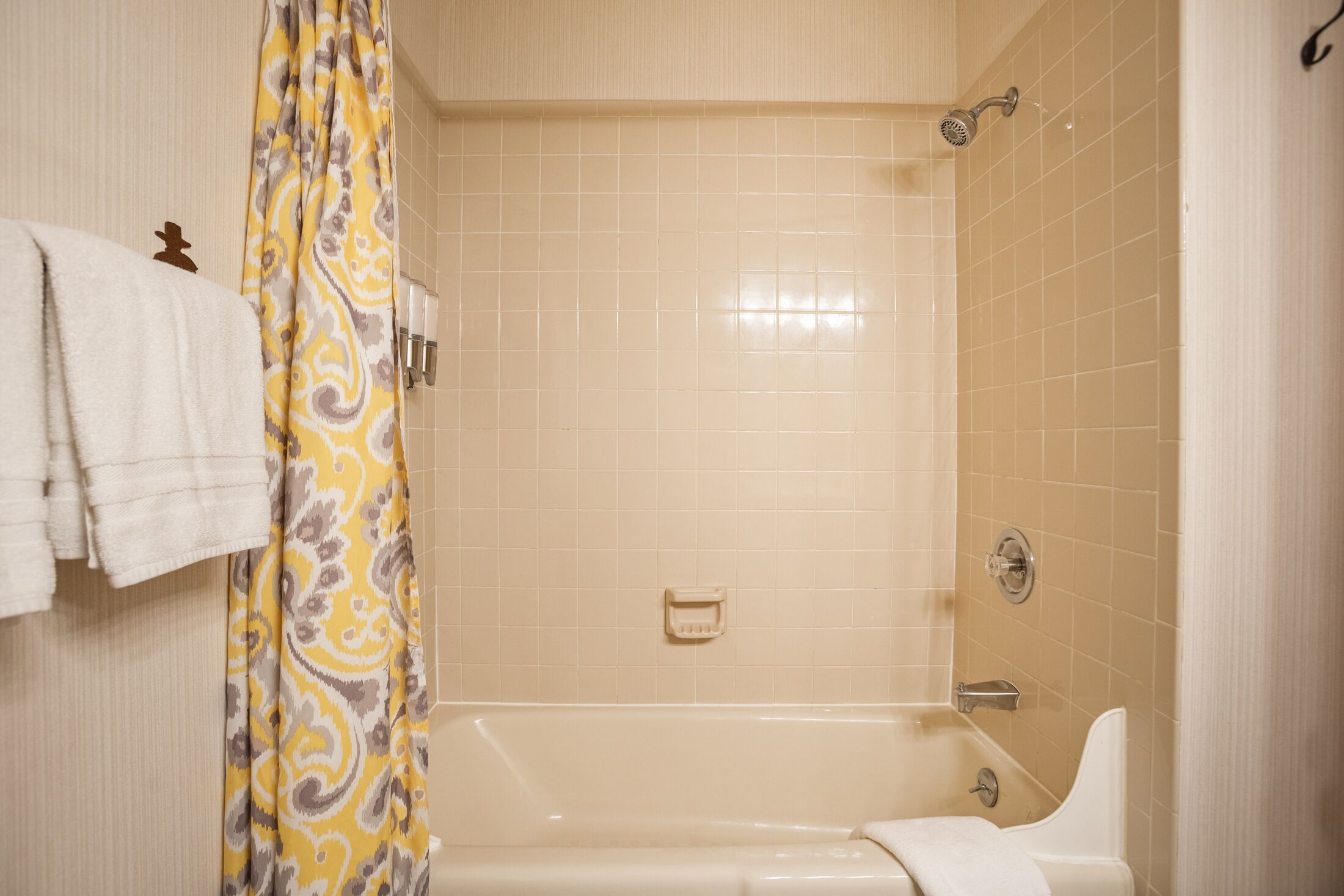 A bathroom with a bathtub, a shower, and a toilet.