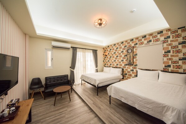 A hotel room with a skylight, a bed, a desk, a TV, and a wall with a flag pattern. - White House (Taitung)