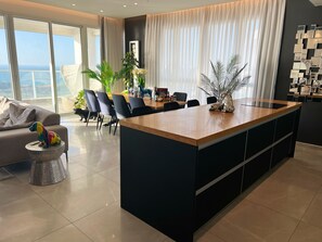 Exclusive Penthouse, 2 Bedrooms, Balcony, Sea View | Living area | 75-inch Smart TV with cable channels, Netflix, pay movies
