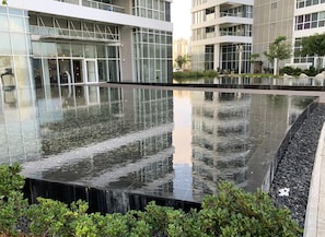 A modern building with a reflective water feature in front. - Prince Palace Netanya Beach Royal Resort (Netanya)