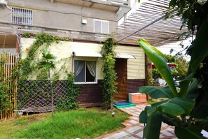 A residential property with a small garden, a wooden fence, and a metal gate. - Fan Zai Cuo (Liuqiu)
