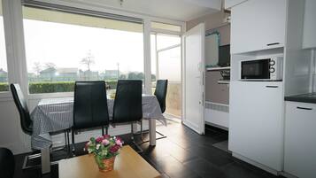 Enjoy meals in the kitchen with a microwave and dining area featuring a table and chairs.
