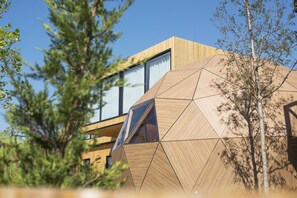 A modern building with geometric wooden panels and large windows. - Moana Eco Surf House - Hostel (Sopelana)