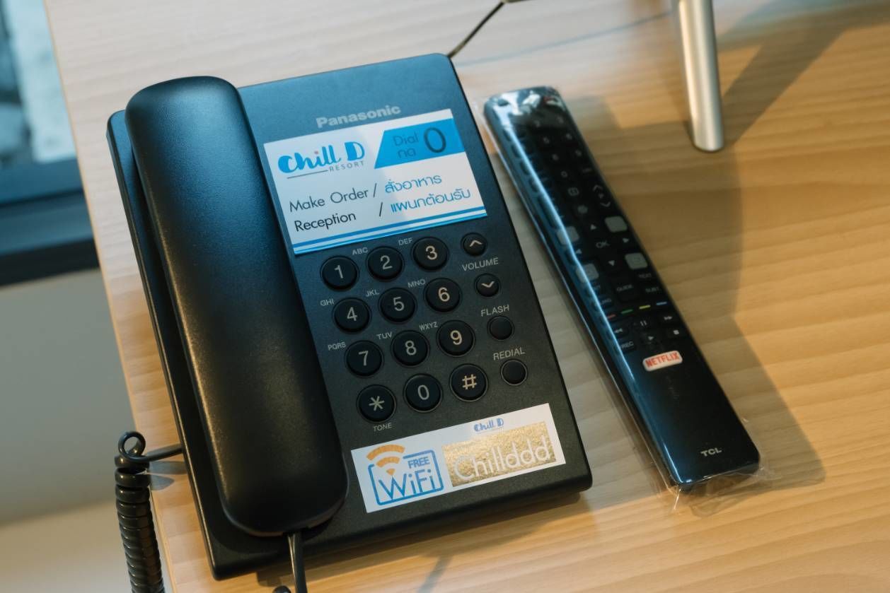 A Panasonic phone with a 'Chill D' label, a remote control, and a 'Free WiFi' sticker.