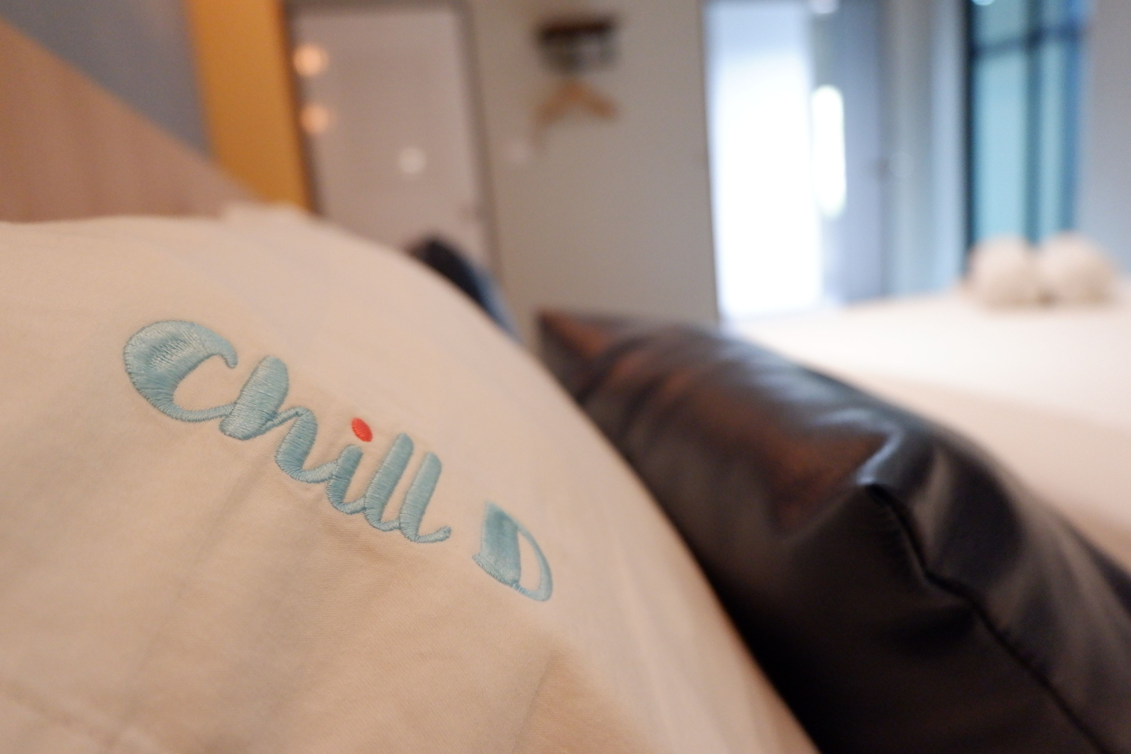 A close-up of a pillow with embroidered text.