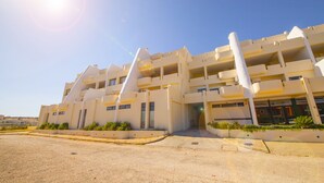 A modern building with multiple balconies and a central entrance. - A08 - Magnólia Sea View Apartment by DreamAlgarve (Lagos)