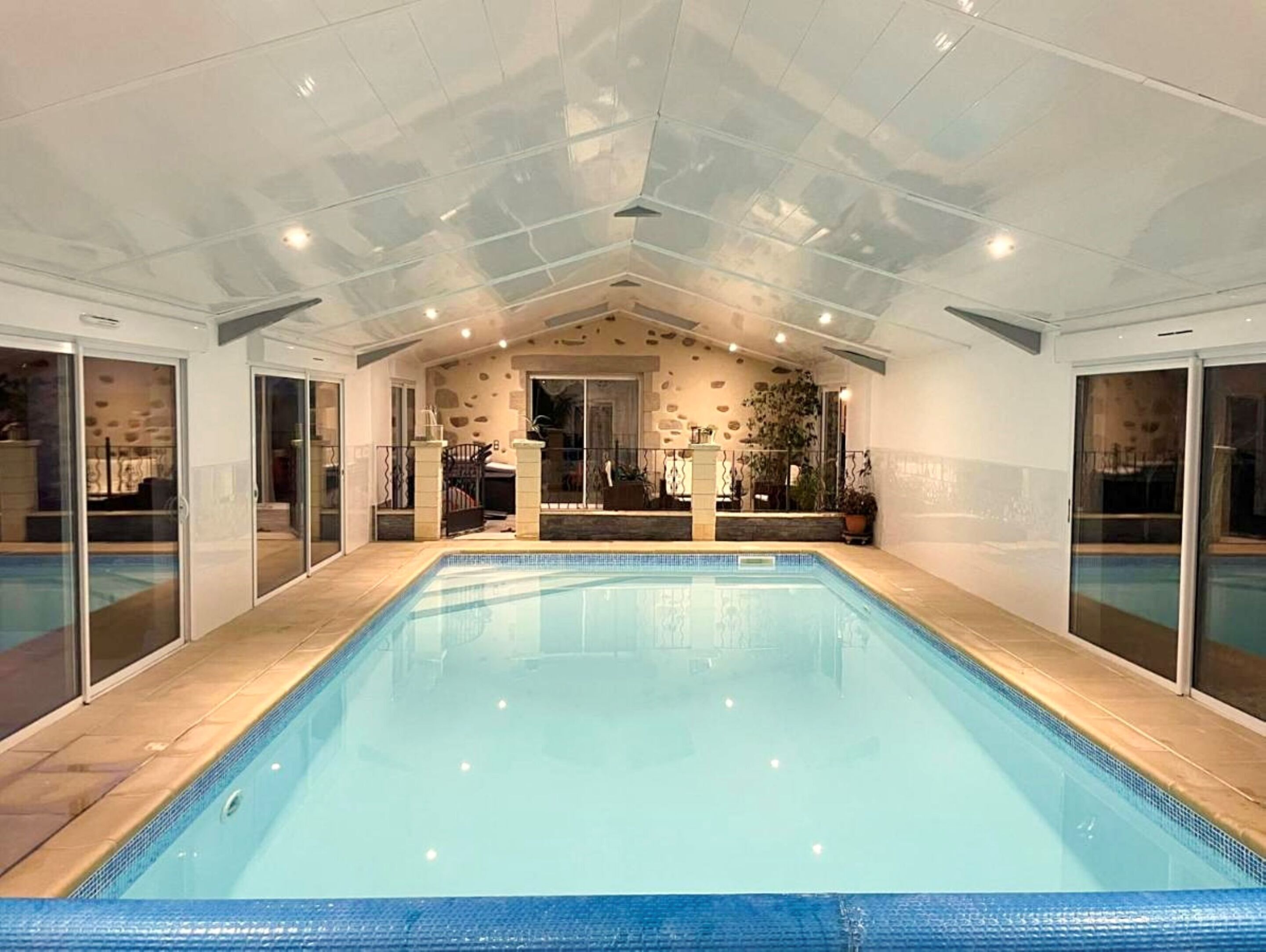 Indoor pool, a heated pool, open 8:30 AM to 9:00 PM, pool umbrellas