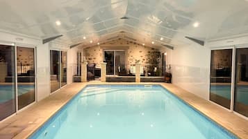 Indoor pool, a heated pool, open 8:30 AM to 9:00 PM, pool umbrellas
