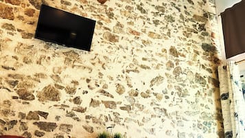 Superior Double Room, Courtyard View | Living area | 80-cm flat-screen TV with digital channels, toys, books