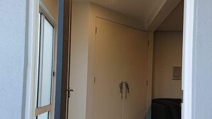 A room with a wooden floor, a white door, and a ceiling light. - Paradise Escapes - 001 (Cowes)