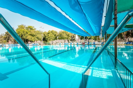 Seasonal outdoor pool, open 10:00 AM to 7:00 PM, pool umbrellas