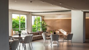 Ein modernes Interieur mit Essbereich, Sofas und einer Treppe.