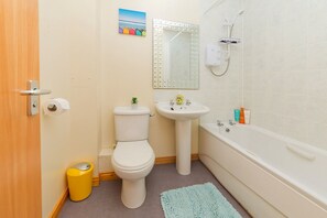 Separate bathtub and shower, free toiletries, hair dryer, slippers