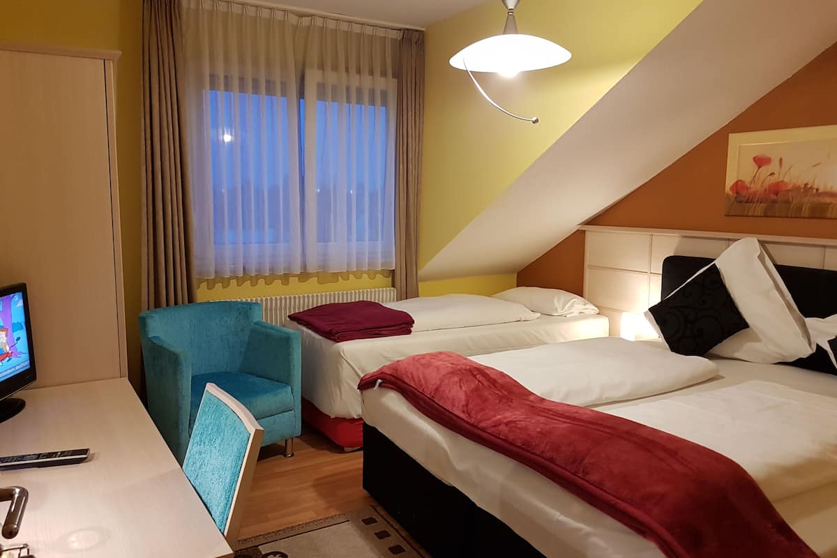 Habitación triple estándar | Escritorio, espacio para trabajar con laptop y cortinas blackout