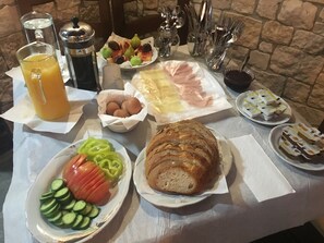 A breakfast buffet with various food items and utensils. - Heraklis Hotel (Berat)