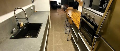 Design Apartment, Multiple Beds | Private kitchen | Coffee/tea maker, electric kettle, cookware/dishes/utensils
