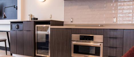 A modern kitchen with a Bosch oven, built-in dishwasher, and a large island.
