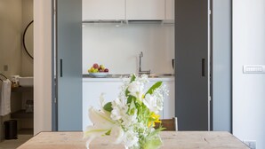 A modern kitchen with white cabinets, a stainless steel sink, and a fruit bowl on the counter. - Rome as you feel - San Lucio Apartments (Rome)