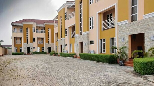 A multi-story building with a courtyard. - Aden 360 Apartments By Intra (Lagos)
