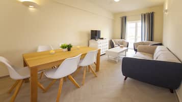 Apartment, 3 Bedrooms | Living area | Flat-screen TV