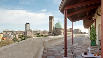 Enjoy a romantic dinner for two on this rooftop terrace with a stunning city view.