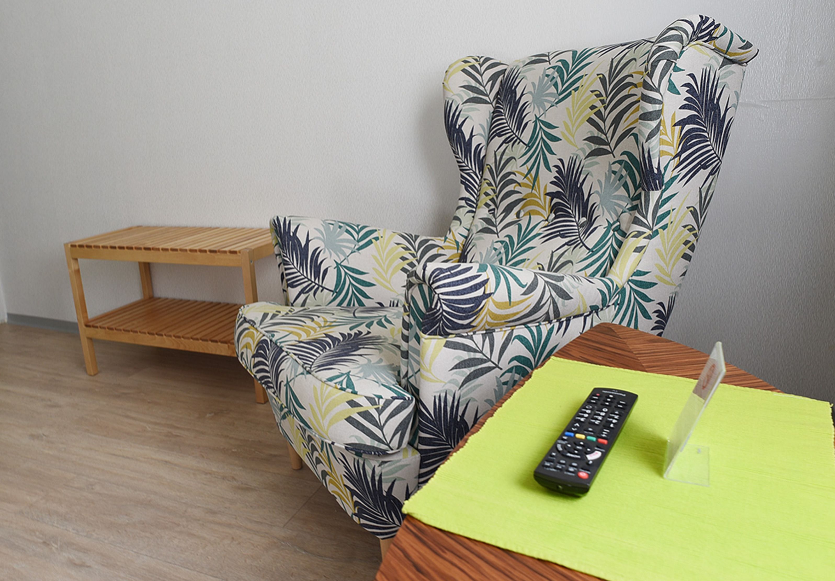 A room with a wooden chair and a small wooden table.