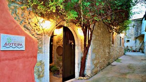 A narrow alleyway with a stone building featuring a sign reading "AOTEIPA". - Dotira, an Enchanting Heritage Home with Pool (Rethimno)