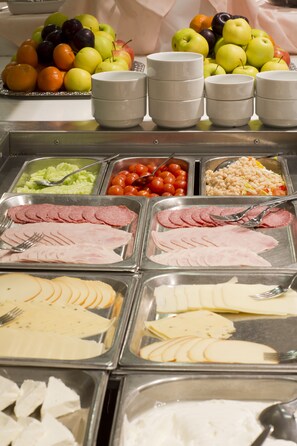 A buffet with various food options including fruits, vegetables, and sliced meats. - Hotel Kolonada (Karlovy Vary)