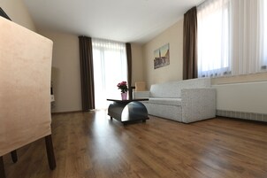 Una sala de estar moderna con un sofá, una mesa de centro y una mesa de comedor.