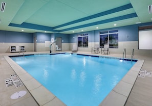 A large indoor swimming pool with clear lane markings and a lifeguard chair. - Holiday Inn Express & Suites Plano - The Colony by IHG (The Colony)