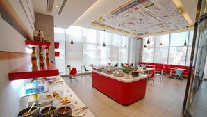 A modern restaurant with a central red island, various food stations, and red and blue seating areas. - Ibis Chengdu Hi-Tech Zone Longhu Hotel (Chengdu)