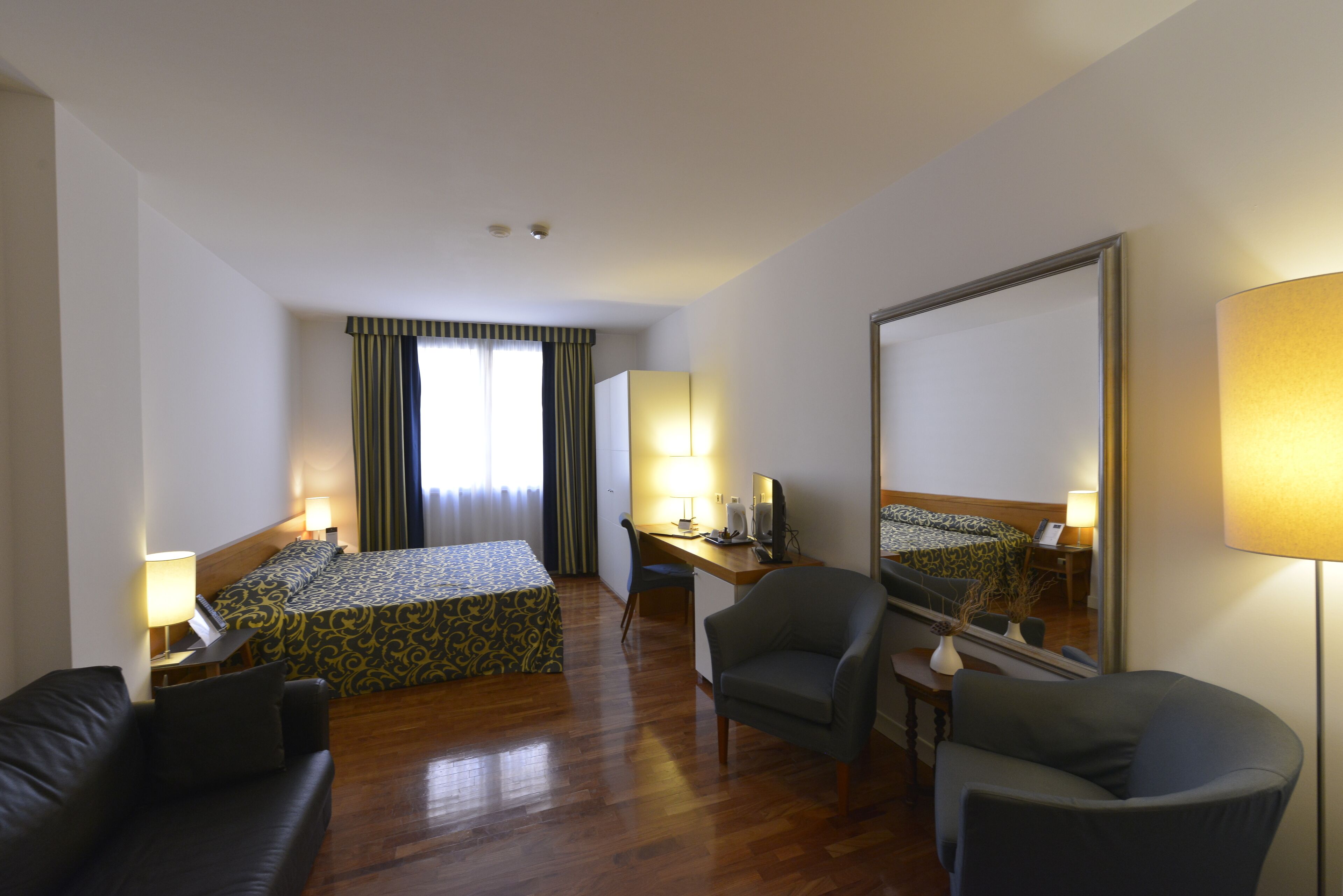 family room | minibar, in-room safe, desk, blackout curtains