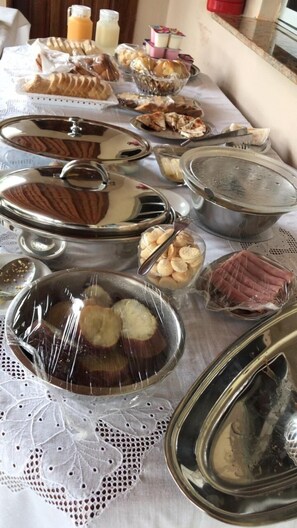 A buffet table with various food items and containers.