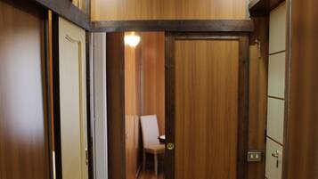 A hallway with wooden walls and a wooden floor.